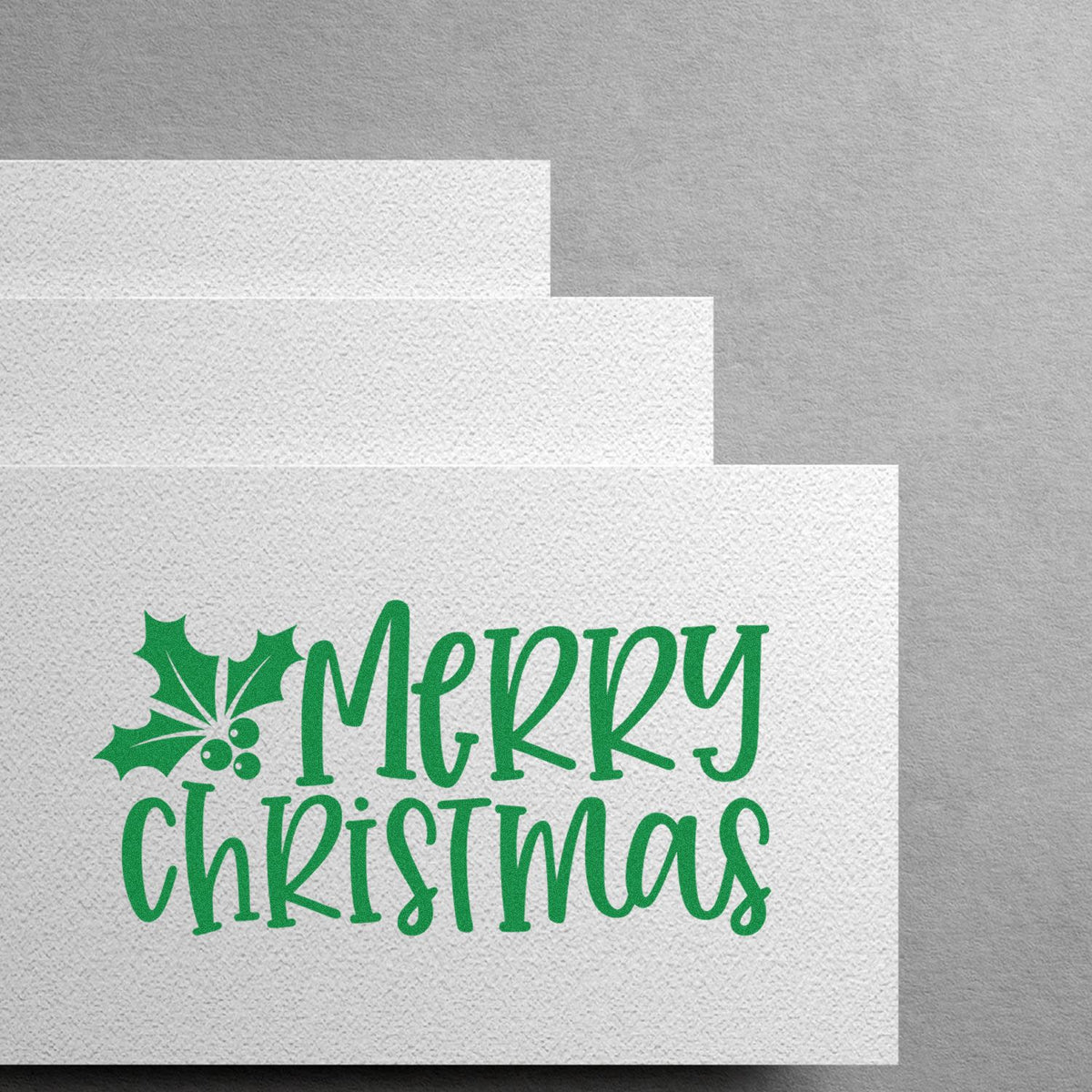 Merry Christmas rubber stamp design with holly, ideal for holiday cards, gift tags, and festive stationery.