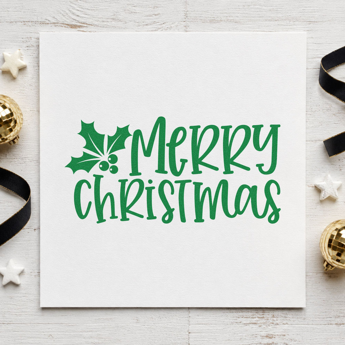 Merry Christmas Holly Corner craft stamp imprint in green ink on a handmade project, one idea being place card slips.