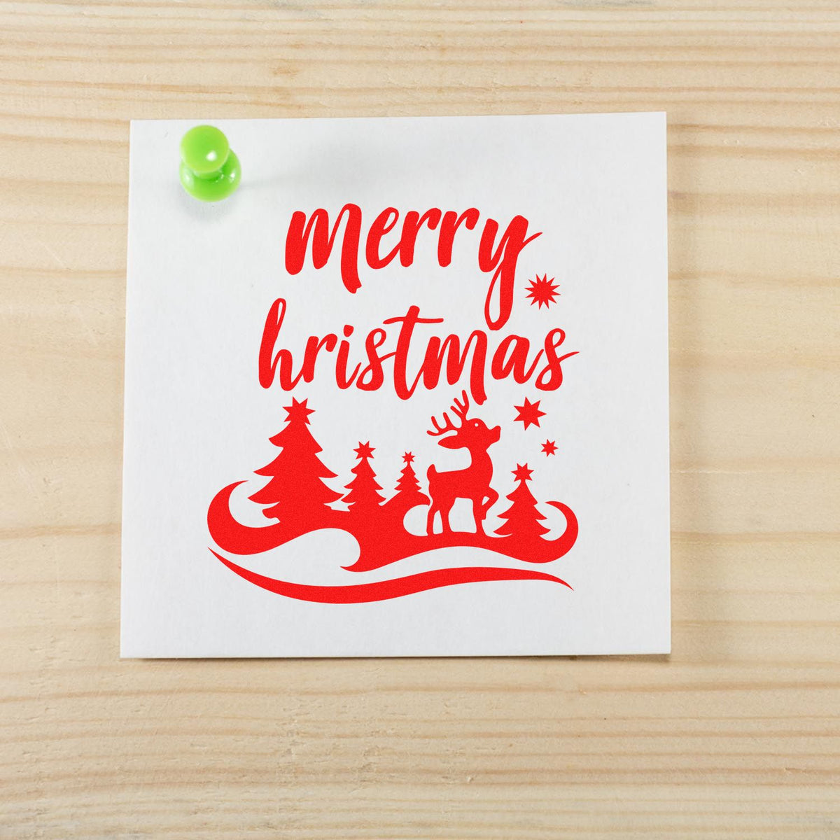 Red Merry Christmas rubber stamp design with reindeer, pine trees and snowflakes on white paper for holiday cards
