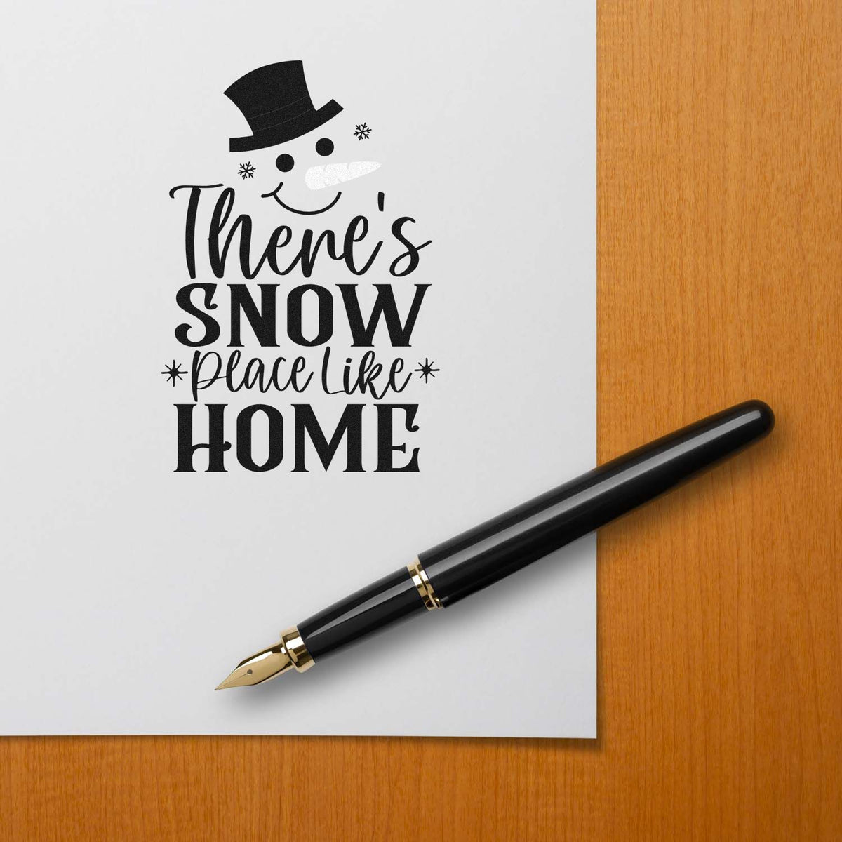 Christmas rubber stamp with snowman and Theres Snow Place Like Home holiday sentiment.