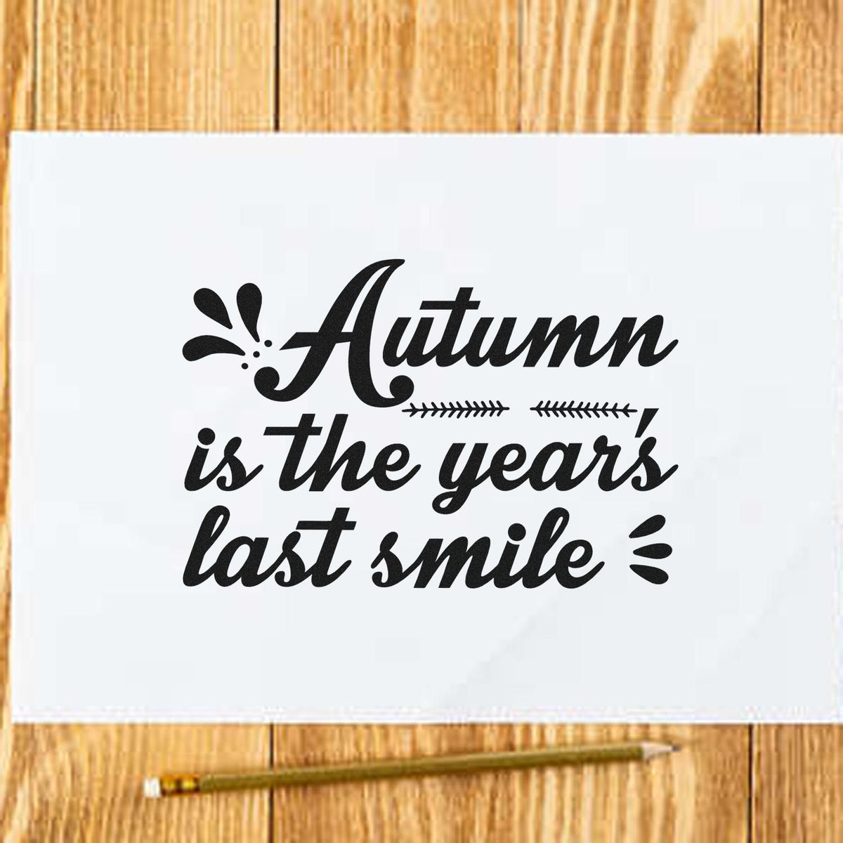 Autumn Is The Year's Last Smile Slim Pre-Inked Stamp imprint stamped in black ink. “Autumn Is the Year's Last Smile” appears in bold italic lettering with leafy accents.