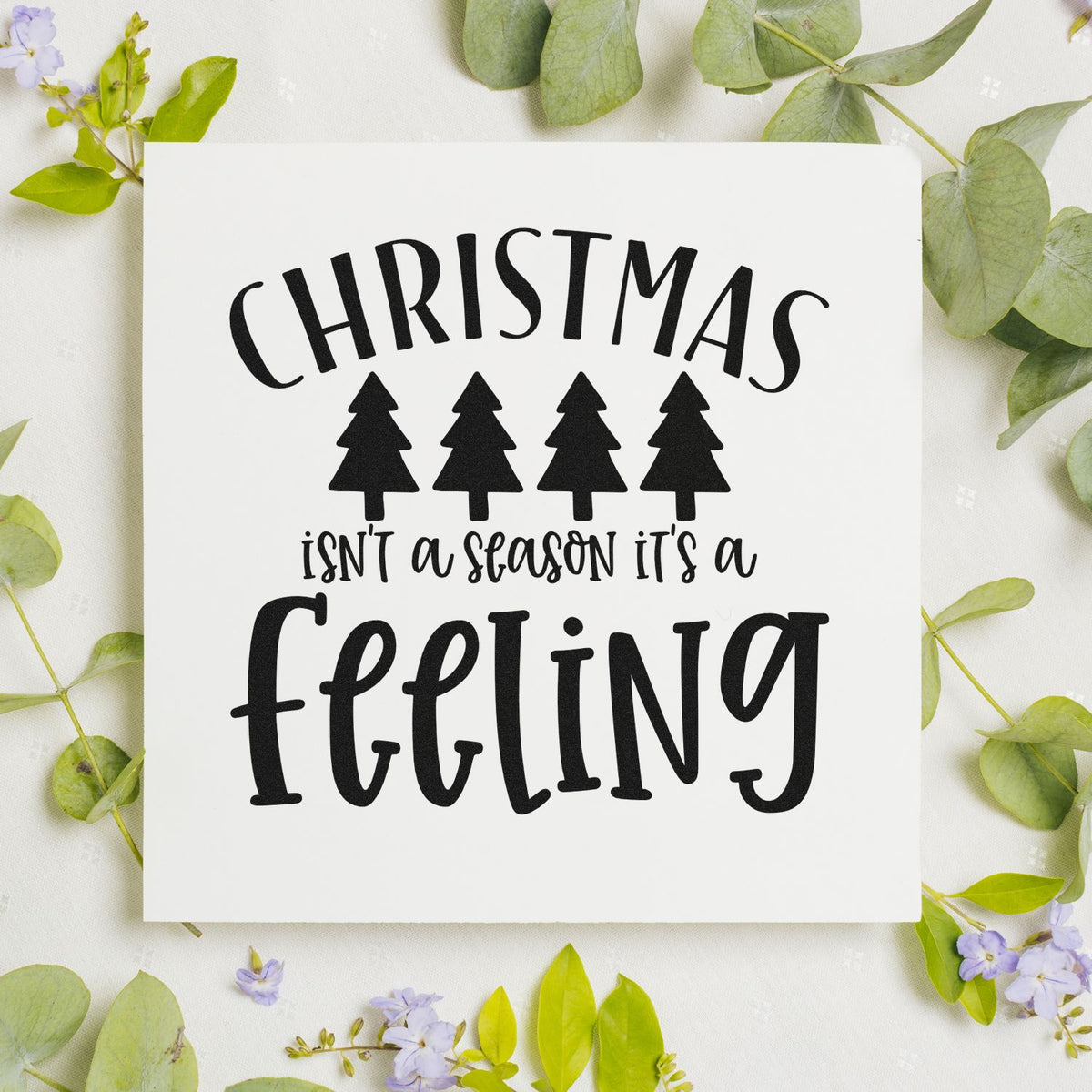 Christmas rubber stamp design with trees and the quote Christmas isnt a season, its a feeling for holiday crafts.