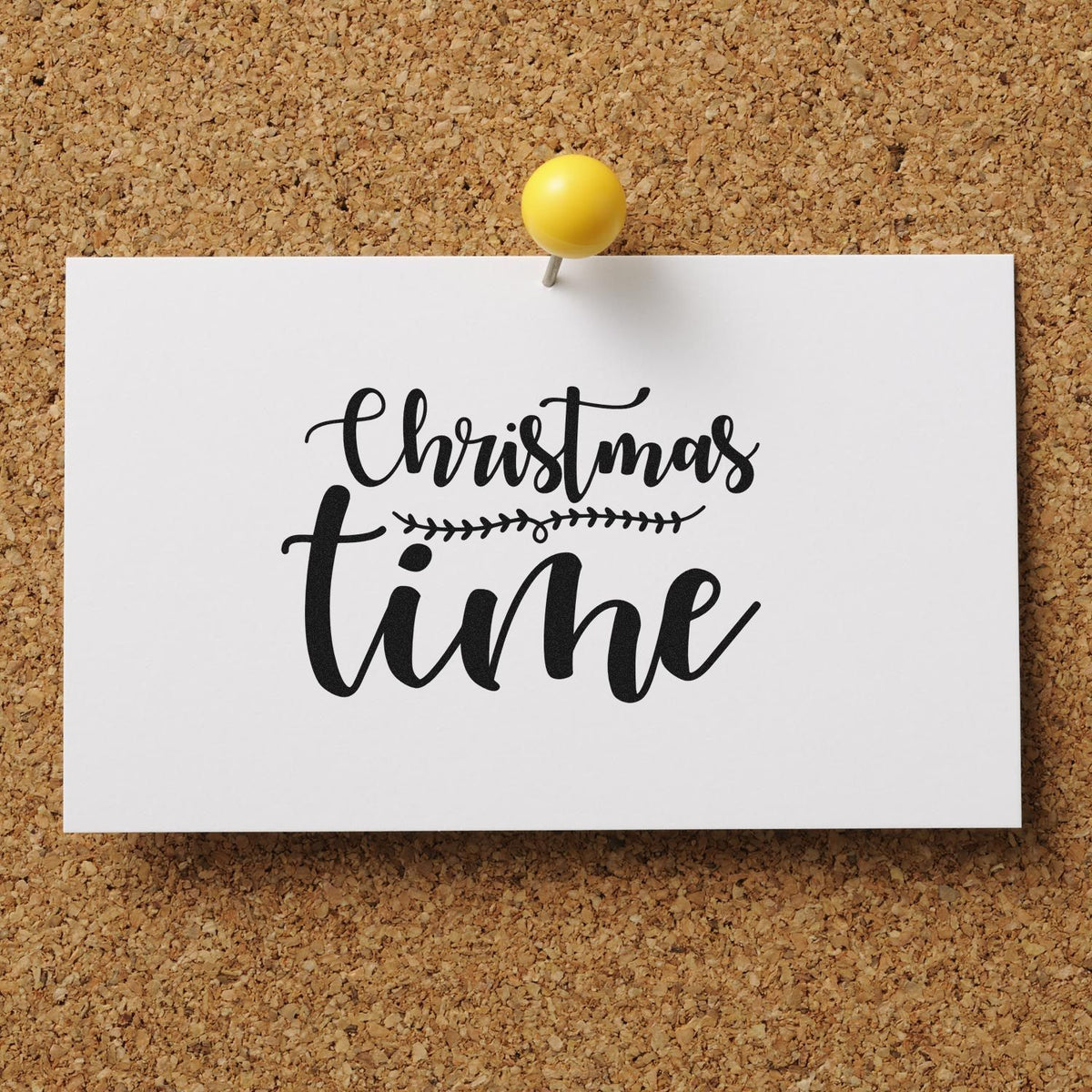 Christmas Time rubber stamp design in script, displayed on a white card pinned to a corkboard.