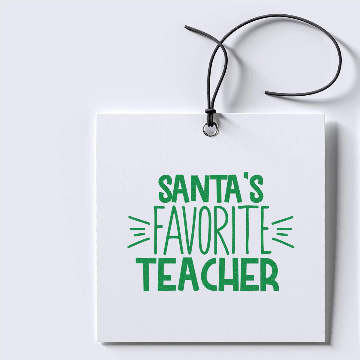 Santas Favorite Teacher rubber stamp design mockup, festive green holiday gift for teachers on a hanging card.