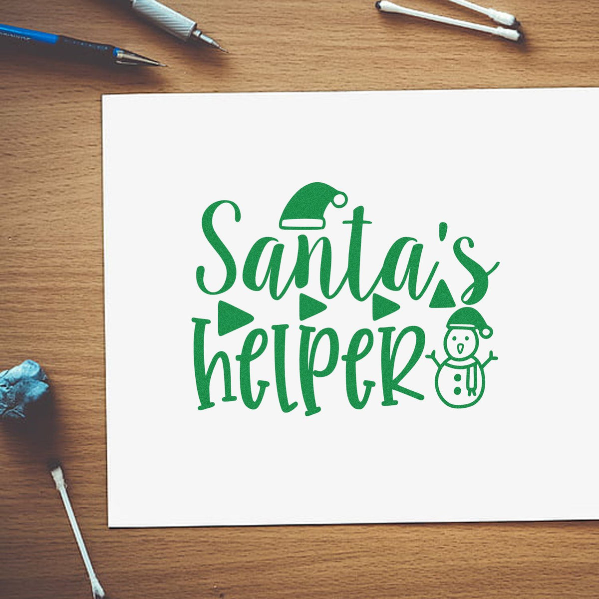 Santas Helper Christmas rubber stamp design in green script with Santa hat and snowman for holiday crafting