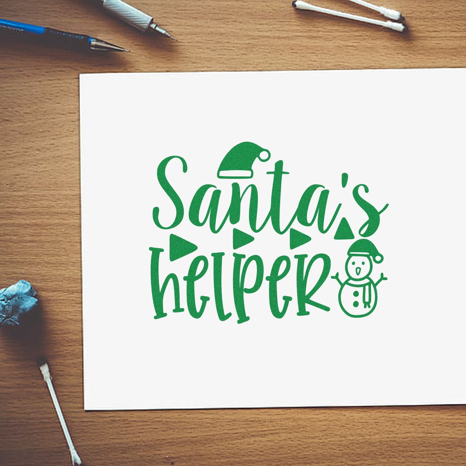 Christmas rubber stamp design reading Santas Helper with snowman on white card for holiday crafts