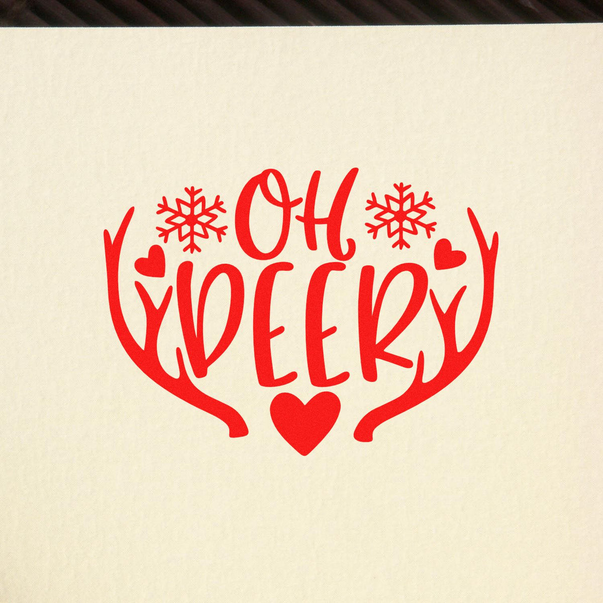 Red "Oh Deer" rubber stamp design with antlers, snowflakes, and hearts for winter and Christmas crafts.