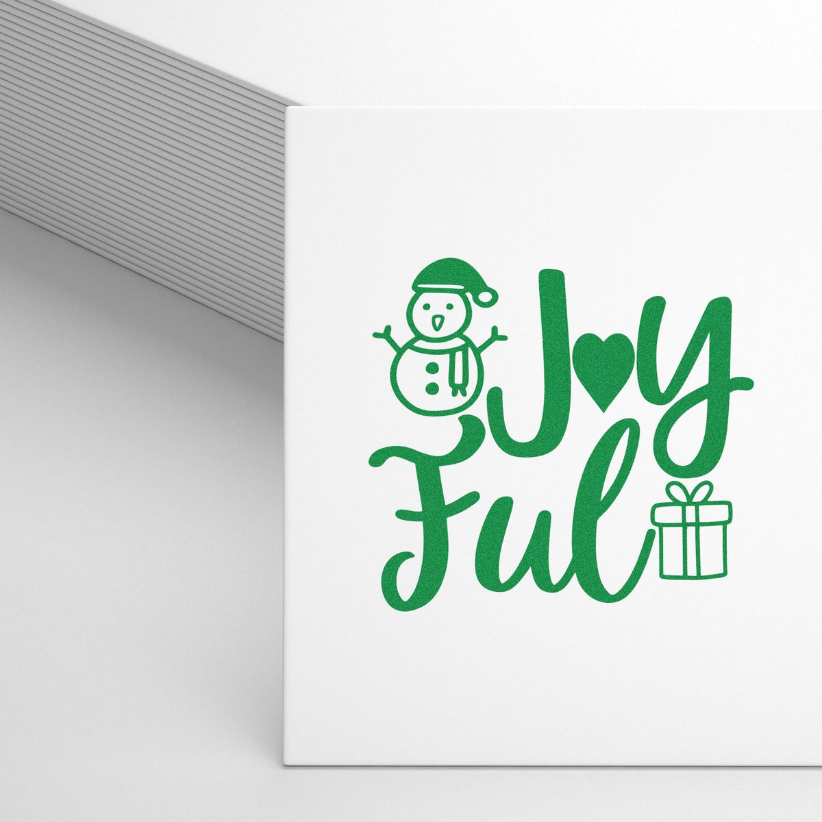 Joyful holiday rubber stamp design with snowman and gift icon for Christmas cards and festive crafts.