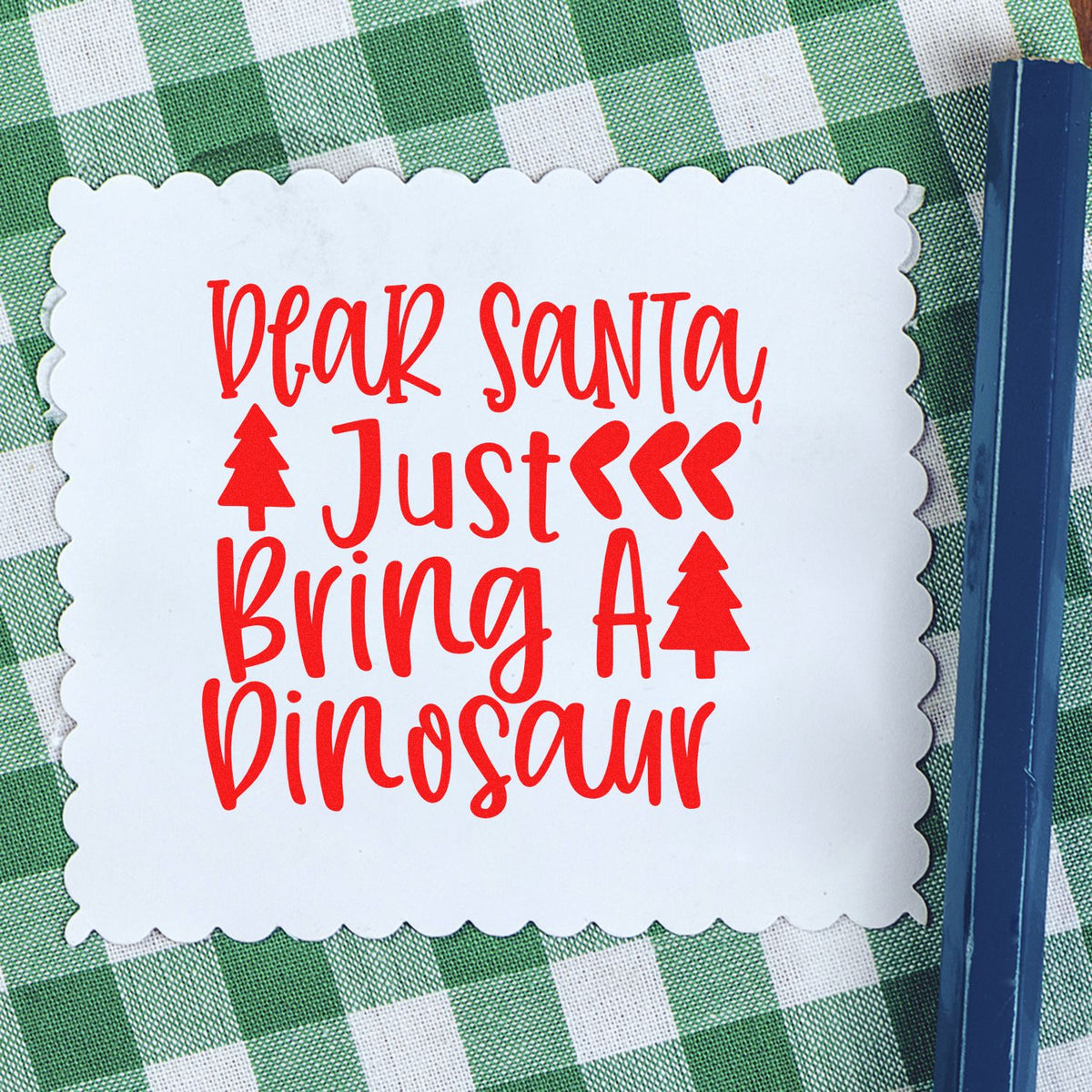 Christmas rubber stamp sentiment reading Dear Santa, Just Bring a Dinosaur in red on a white card.