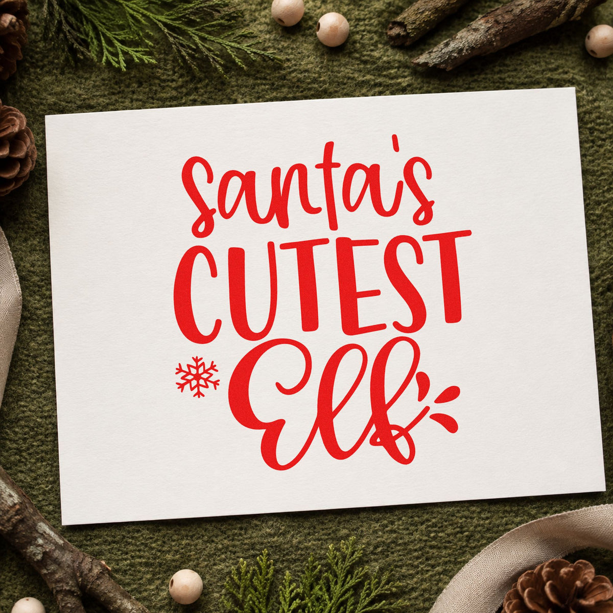 Santa's Cutest Elf Lettering craft stamp in red ink on cardstock, an easy option for stocking name tags.