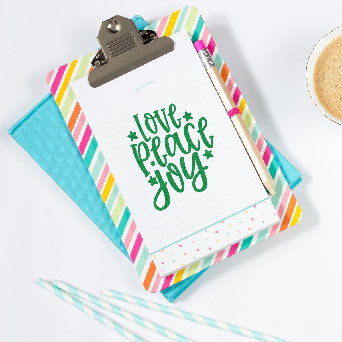 Love Peace Joy rubber stamp design on colorful clipboard stationery for card making and paper crafting.