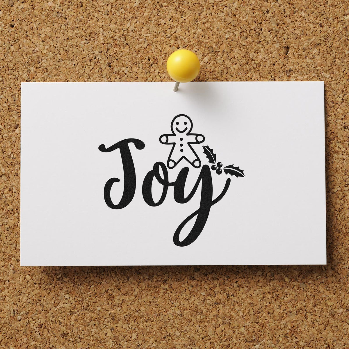 Joy Christmas rubber stamp design with gingerbread and holly on pinned white card display