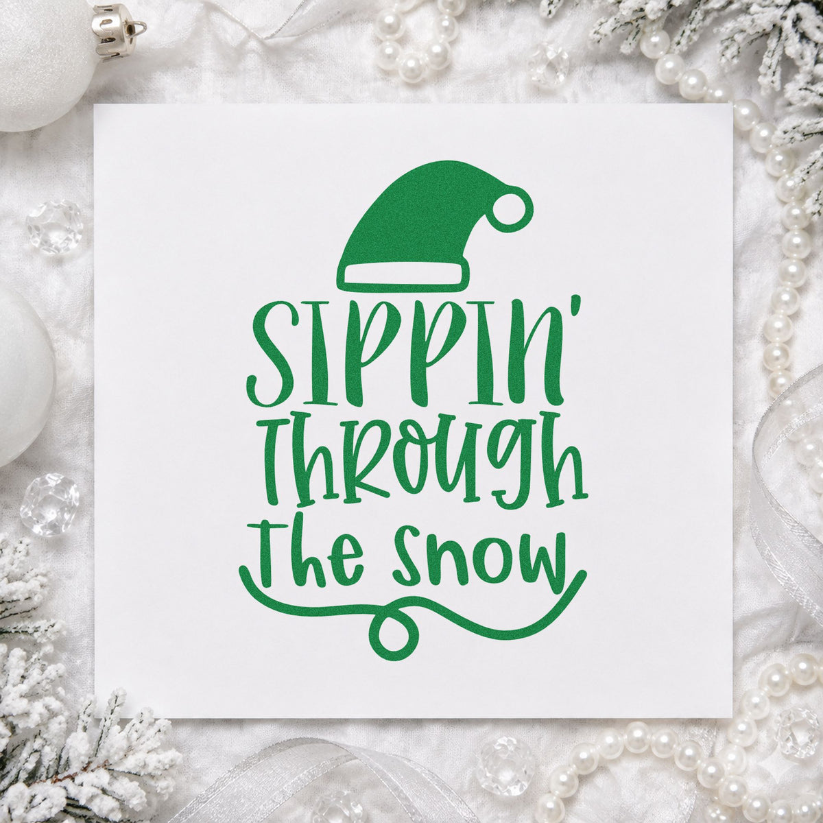Sippin Through The Snow craft stamp imprint in green ink on a handmade project, one idea being batch jug tags.