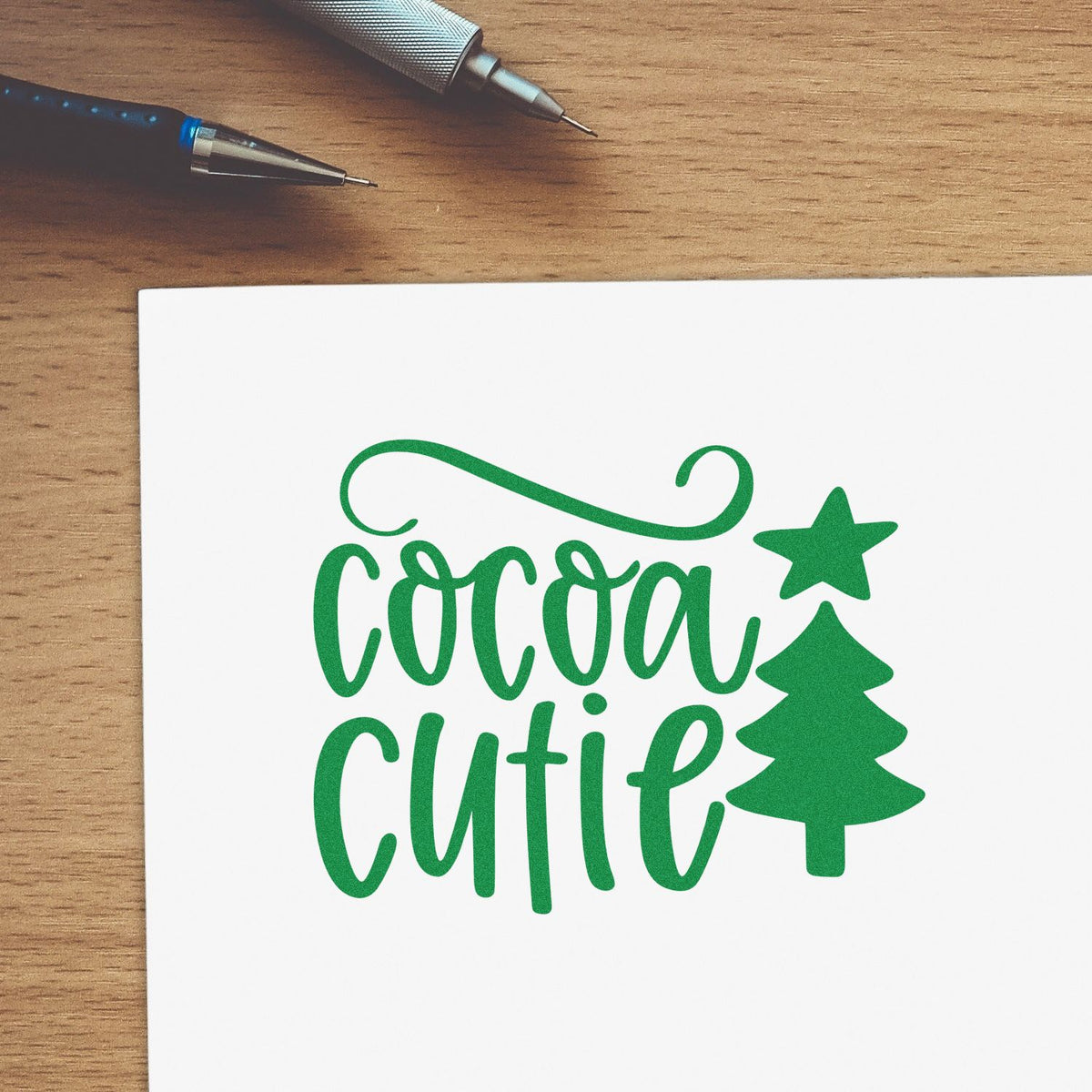 Cocoa Cutie Christmas rubber stamp design with green holiday lettering and tree icon for festive card making.