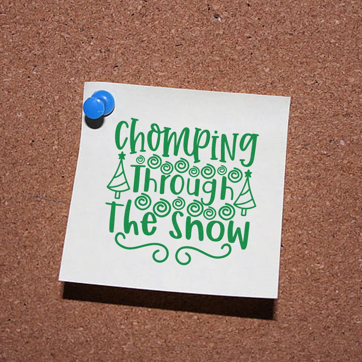 Chomping Through the Snow Christmas rubber stamp design in green on pinned note, with holiday trees and swirls.