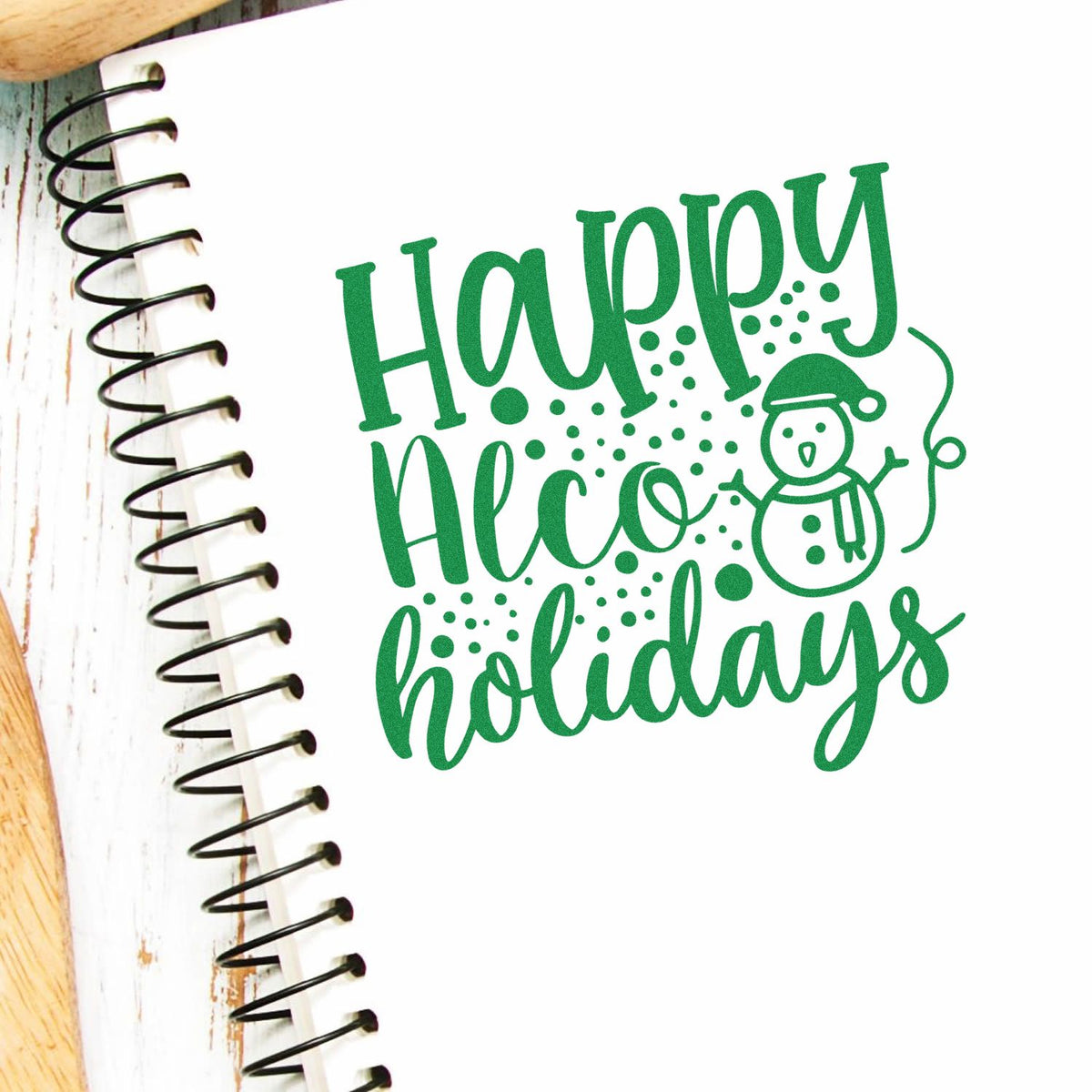 Happy Holidays rubber stamp design with snowman on spiral notebook, perfect for festive card making and holiday crafts.