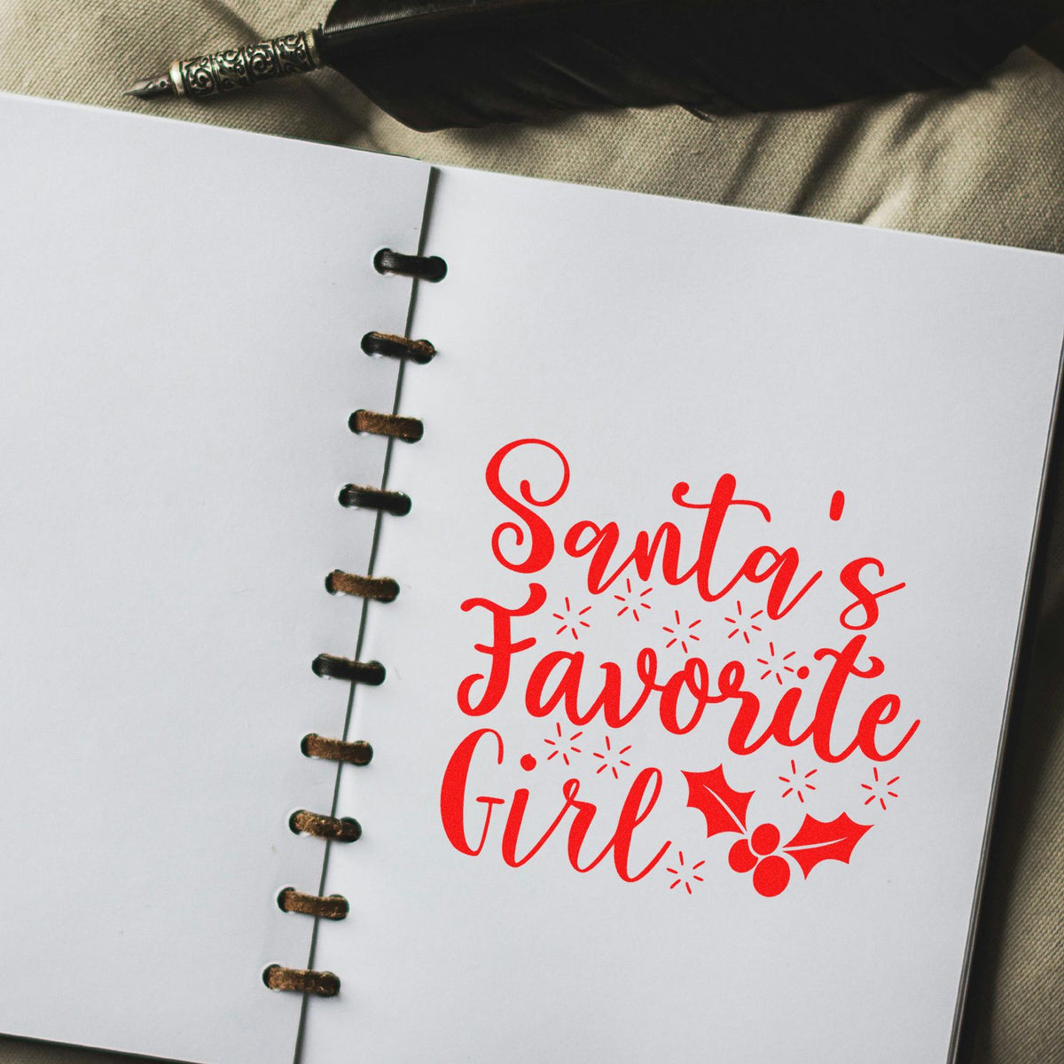 Santas Favorite Girl holiday rubber stamp design in red on a notebook page with holly accents.