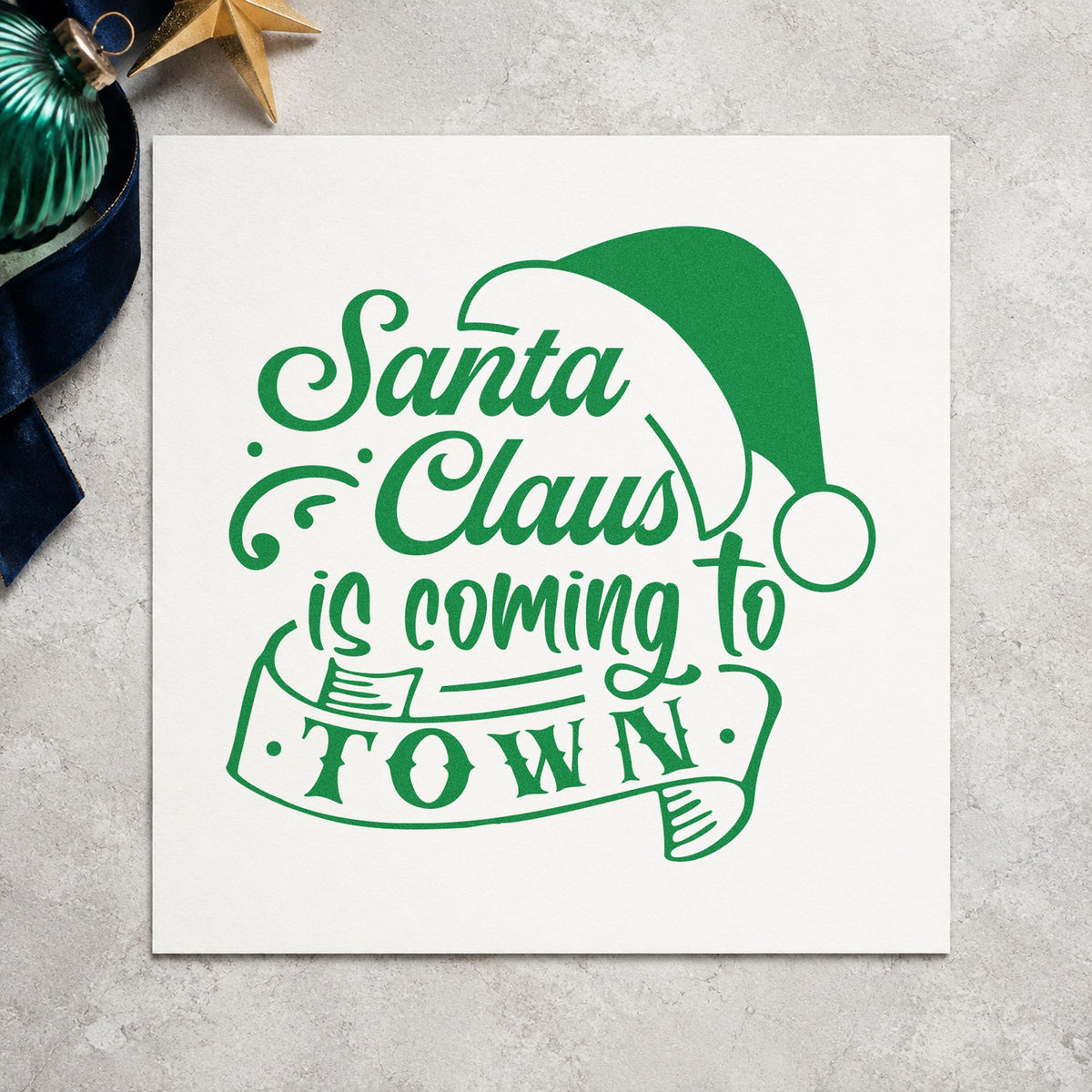 Santa Claus Coming To Town craft stamp imprint in green ink on a handmade project, one idea being photo order cards.