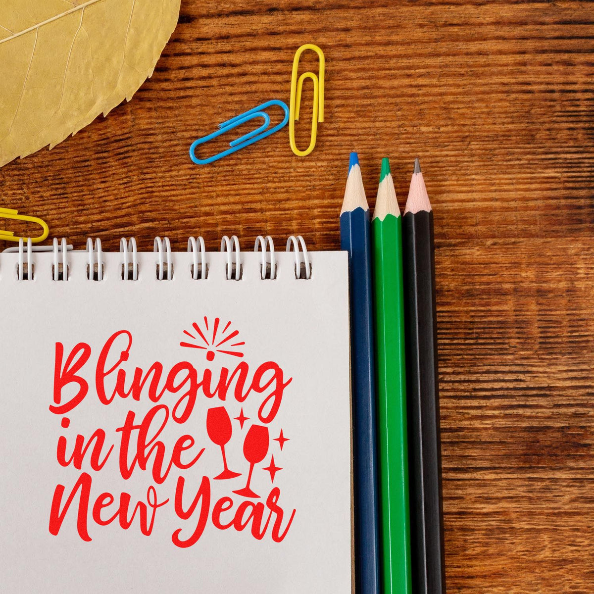 Festive New Year rubber stamp design reading Blinging in the New Year with champagne glasses and sparkle icons.