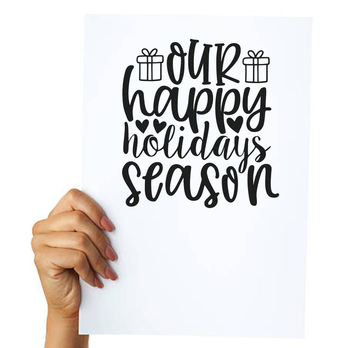 Hand holding paper with Our Happy Holidays Season rubber stamp design, with gift icons and hearts for festive cards.