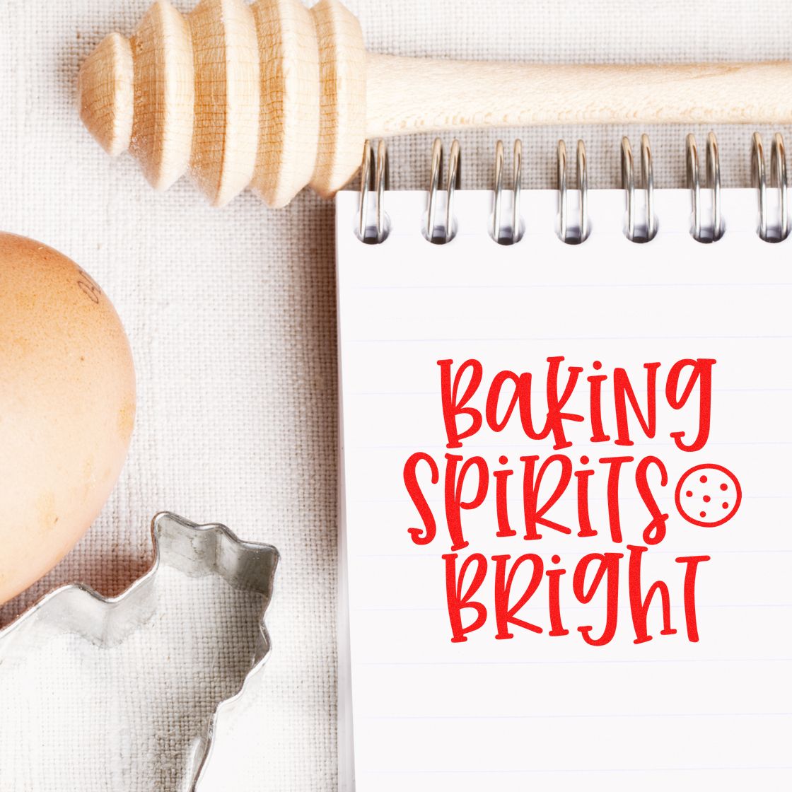 Baking Spirits Bright rubber stamp design on notepad with cookie cutter, egg, and rolling pin for festive holiday baking.