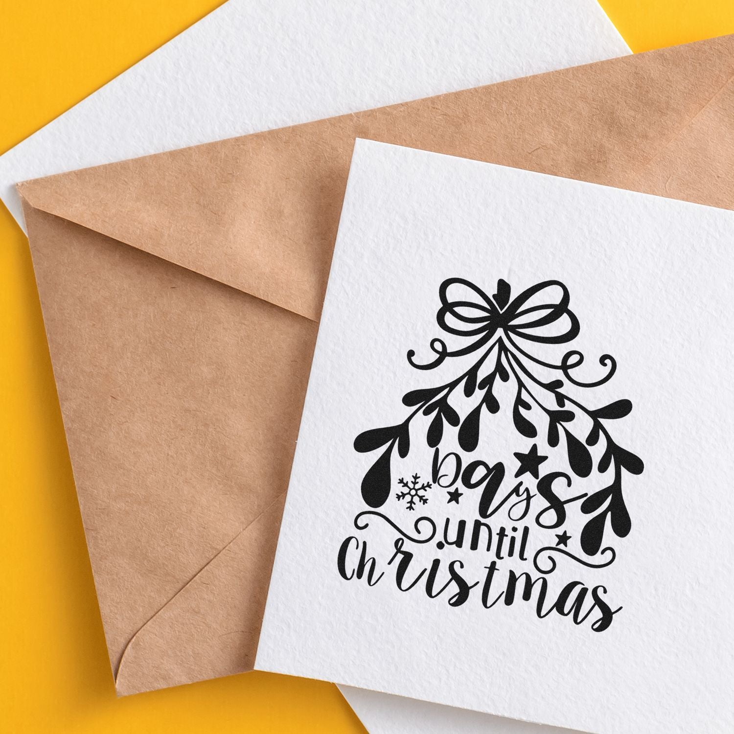 Christmas rubber stamp card with days until Christmas holiday countdown on paper and kraft envelope.