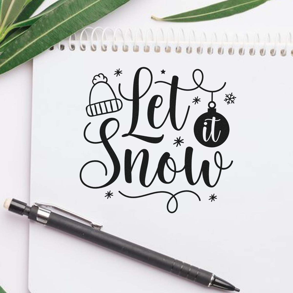 Let It Snow winter rubber stamp design with hat and ornament, ideal for holiday cards and crafts.