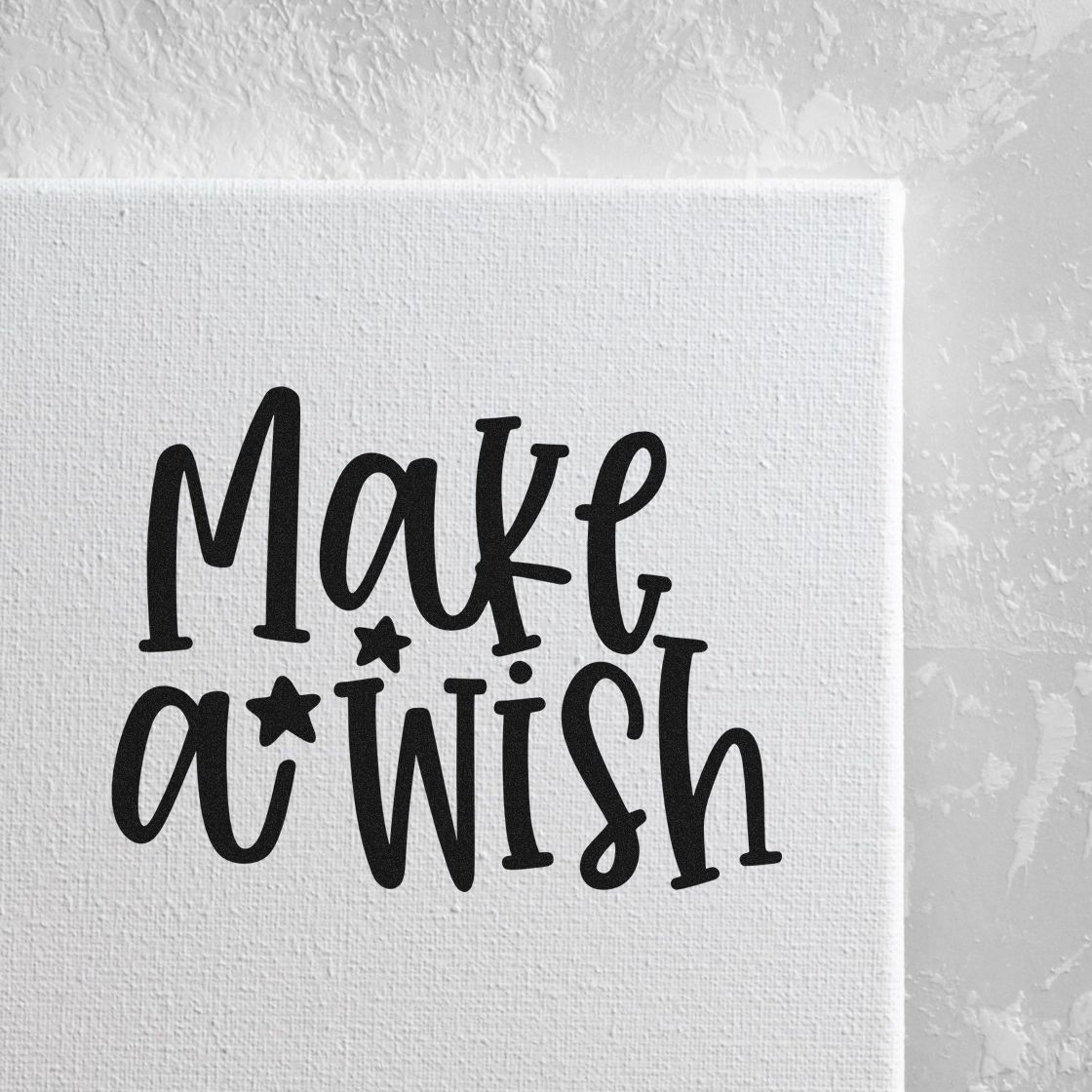Make A Wish Stamp – Slim Pre-Inked imprint stamped in black ink. The words "Make a wish" stack in playful lettering with three small stars.