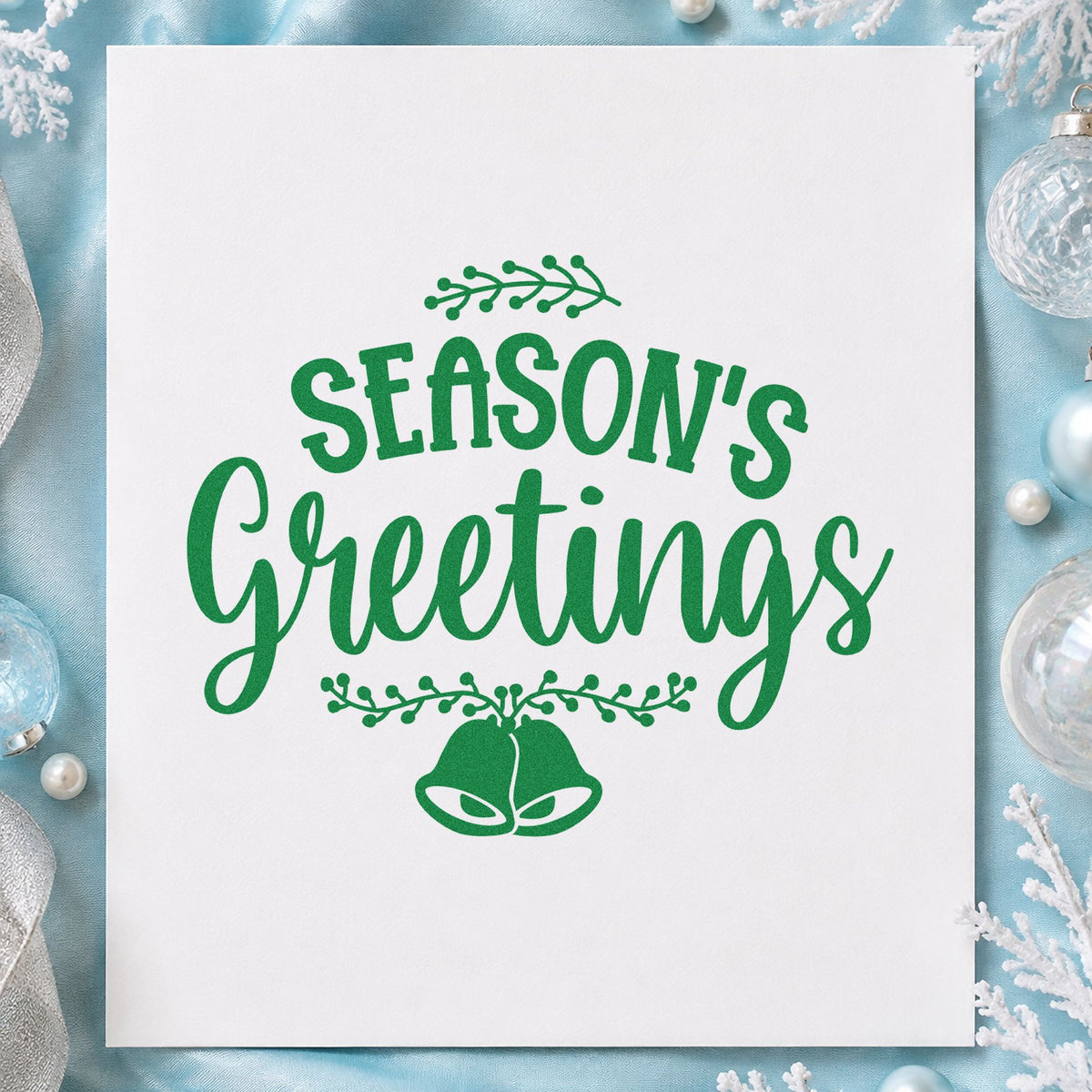 Season's Greetings Hanging Bells craft stamp imprint in green ink on a handmade project, one idea being double chime tags.