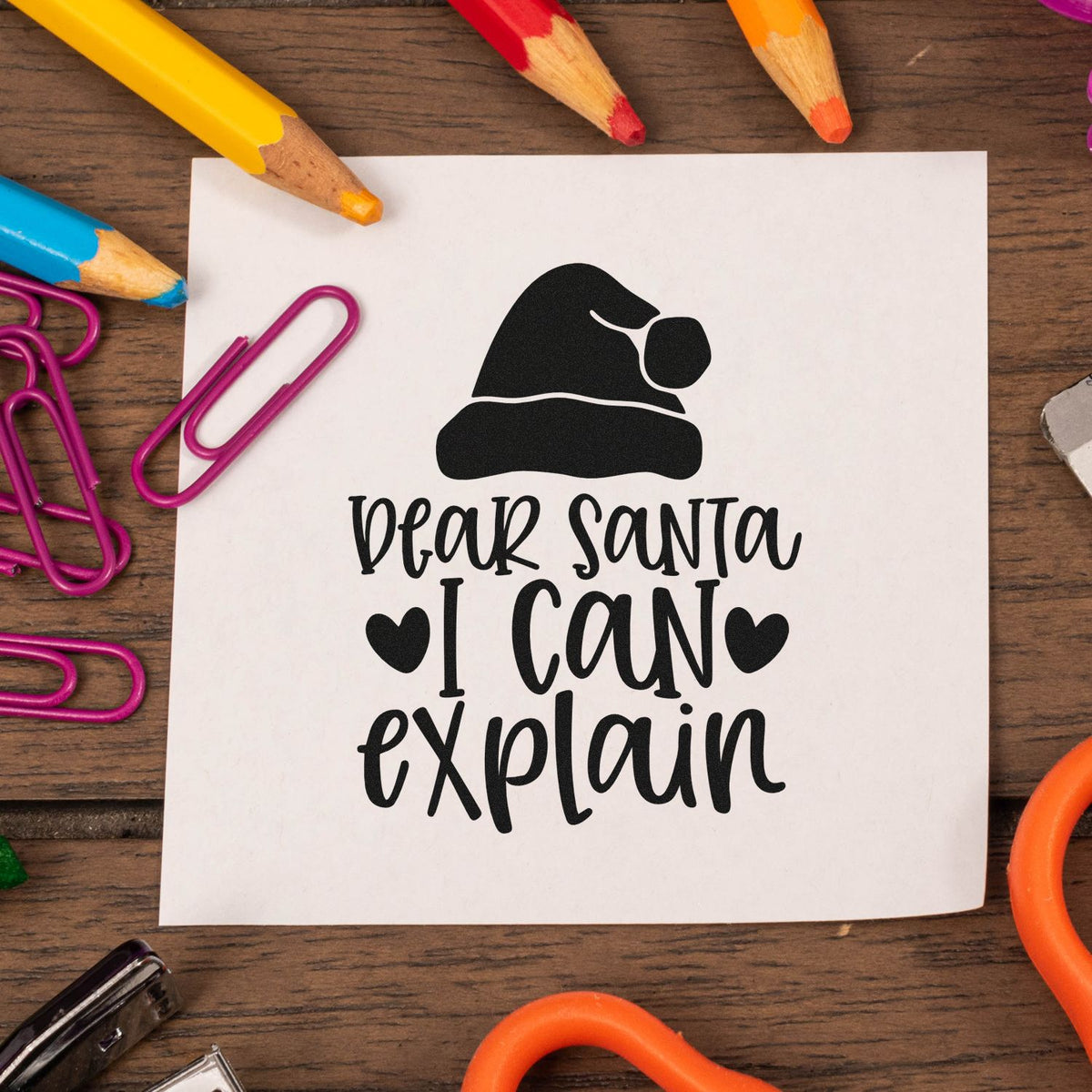 Christmas rubber stamp design with Santa hat and Dear Santa I can explain text for holiday cards and craft projects.
