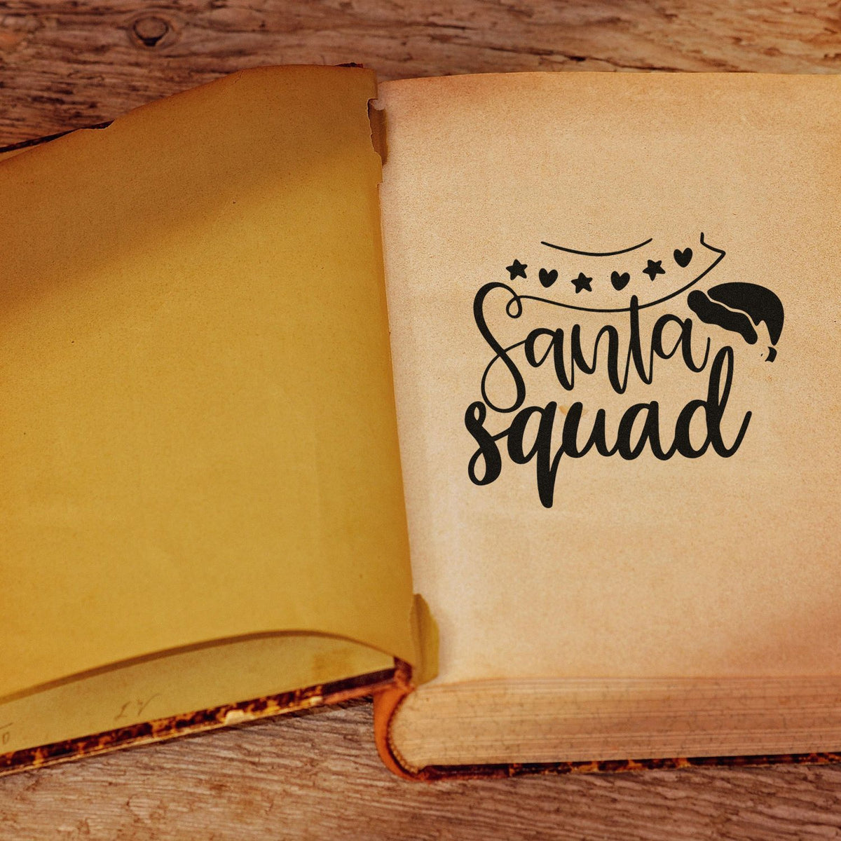 Santa Squad Christmas rubber stamp design on an open book page, perfect for festive holiday crafting and card making.