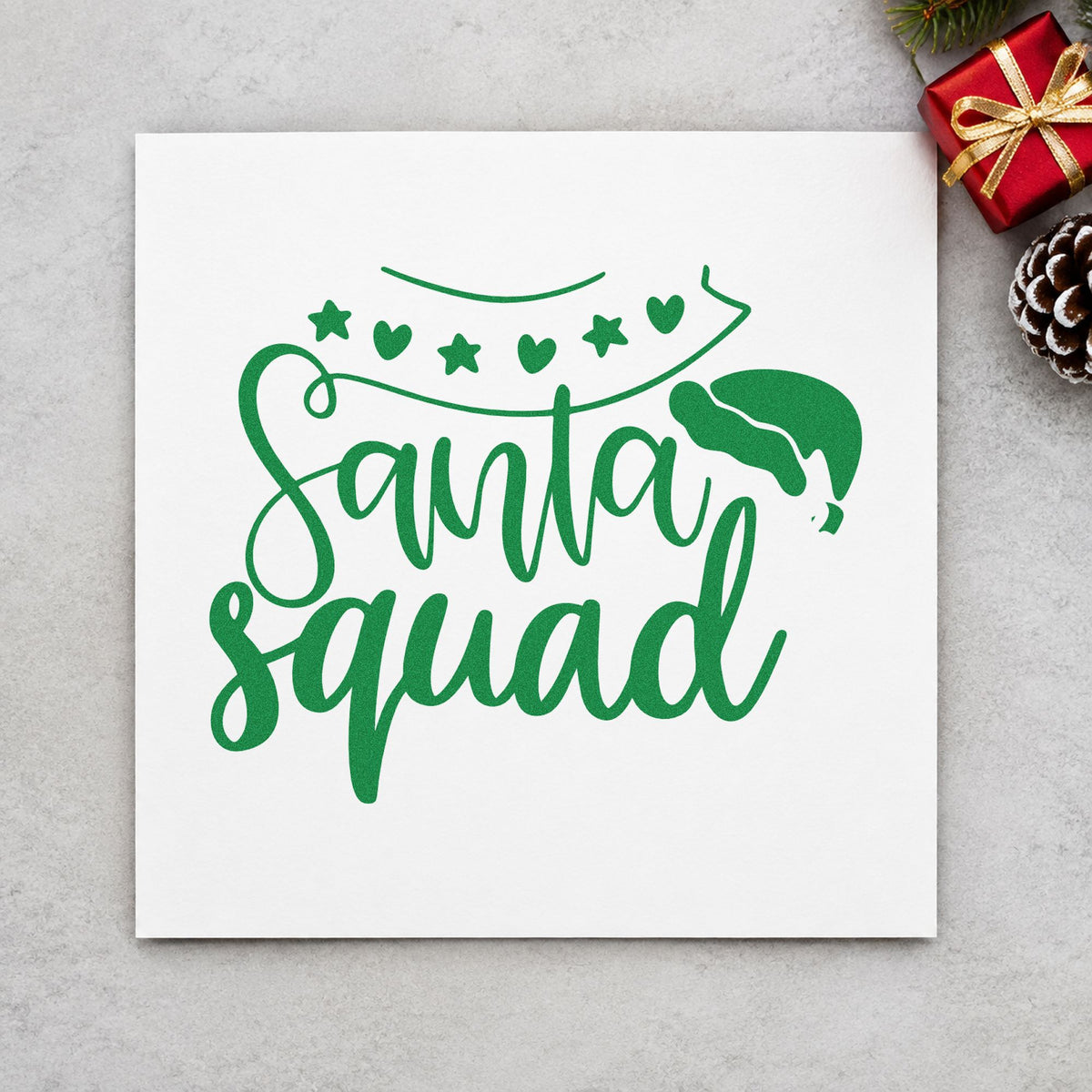 Santa Squad Heart Garland craft stamp imprint in green ink on a handmade project, one idea being party entry cards.