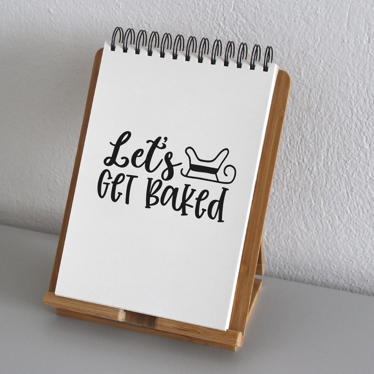 Let's Get Baked Sleigh Outline Detail Premium Wooden Stamp - Vintage Pro imprint stamped in black ink. The words "Let's get baked" appear beside an outlined sleigh.