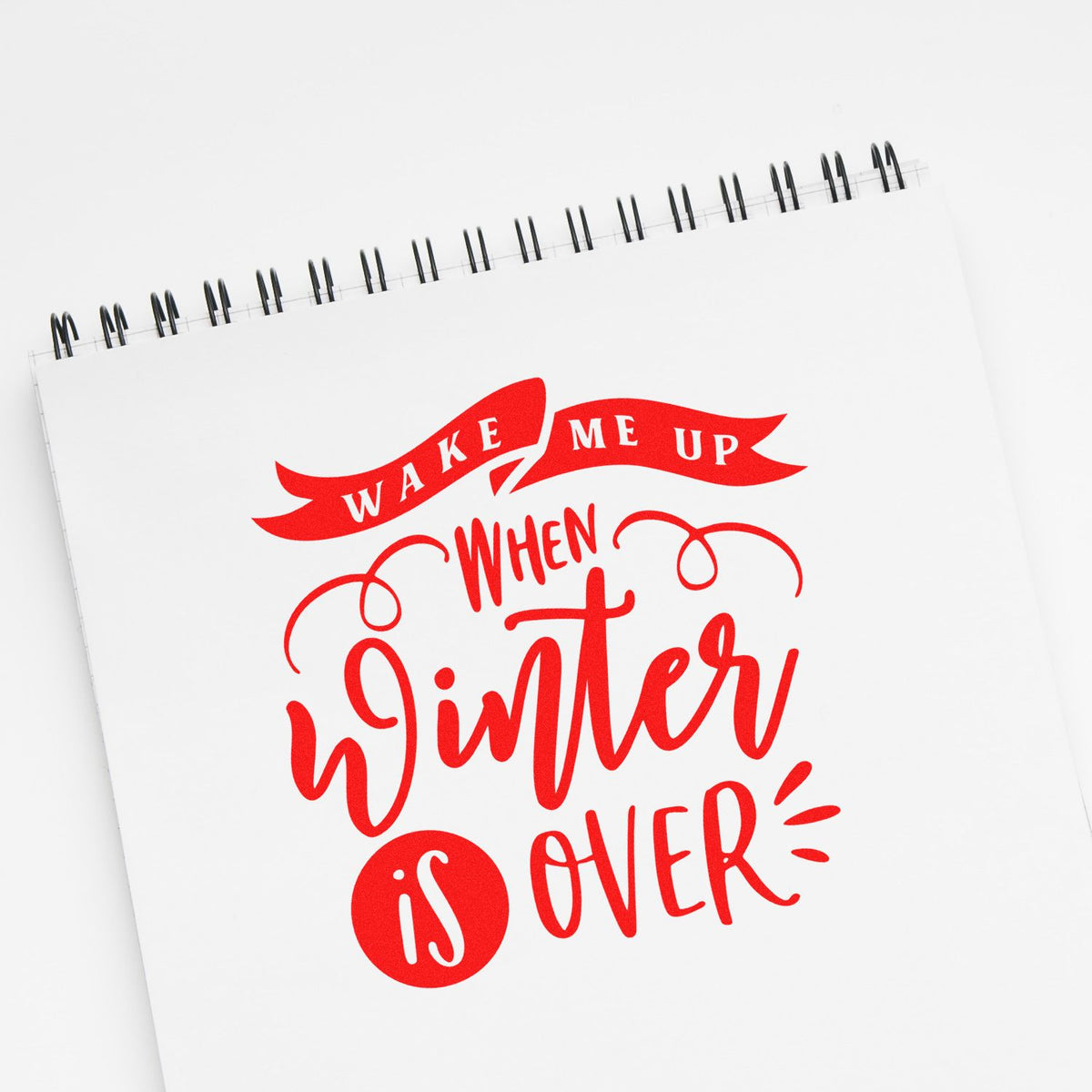 Wake Me Up When Winter Is Over rubber stamp design in bold red lettering, ideal for planners, cards, and seasonal crafts.