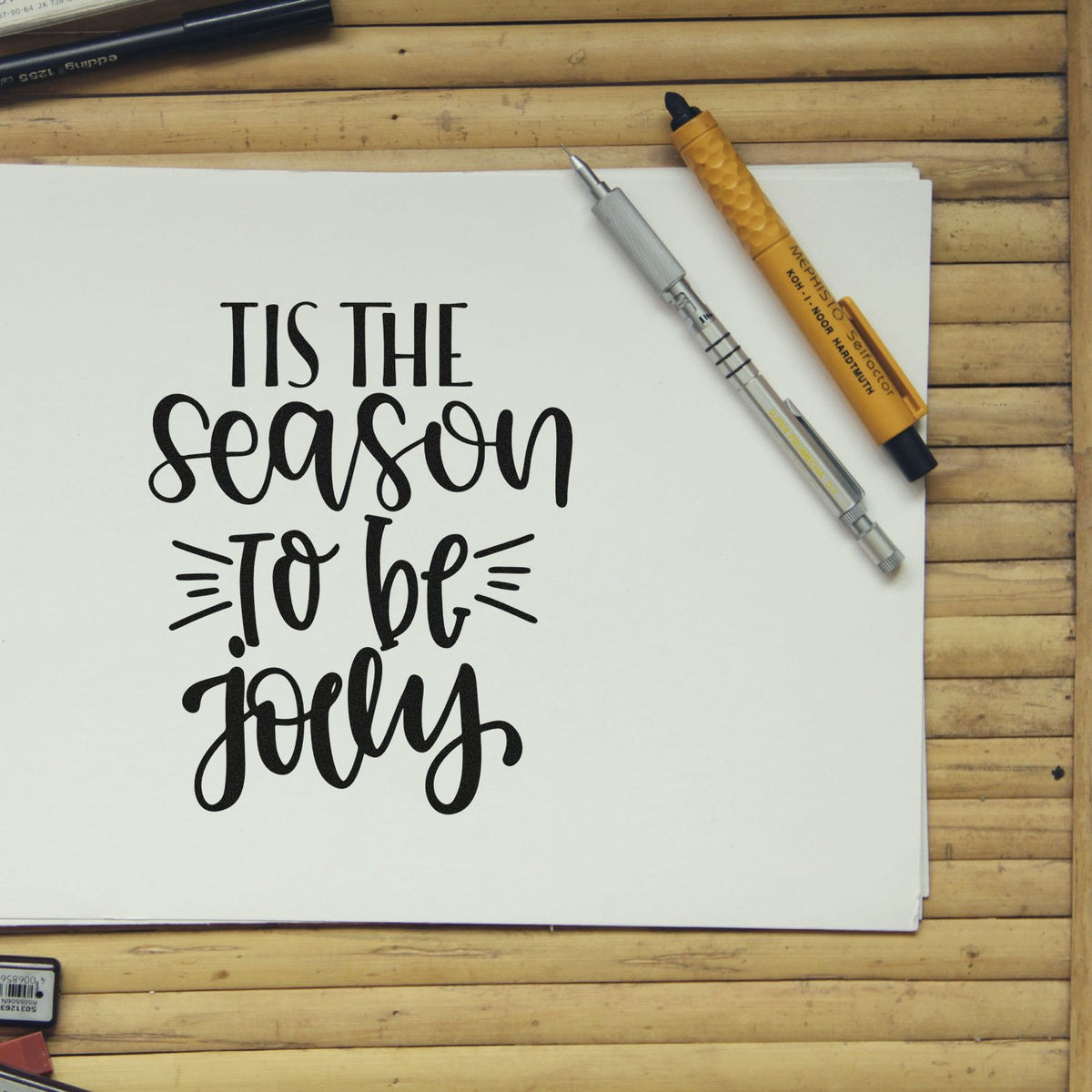 Holiday rubber stamp design with Tis the season to be jolly hand lettering for Christmas cards and craft projects.