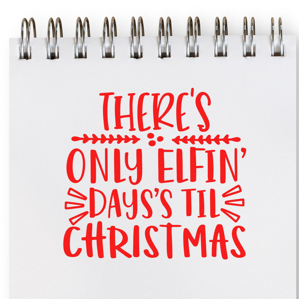 Christmas rubber stamp design with red text reading Theres only elfin days til Christmas on a spiral notebook page.
