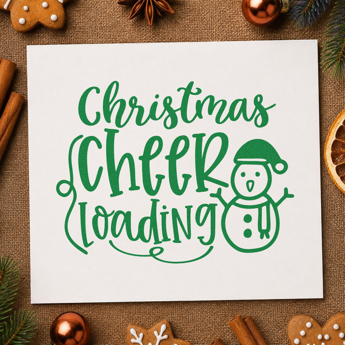 Christmas Cheer Loading Snowman craft stamp imprint in green ink on a handmade project, one idea being scarf kit gift tags.