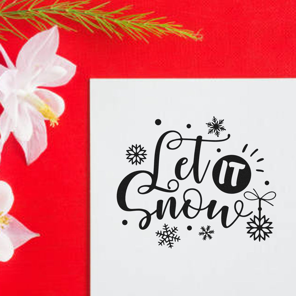 Let it snow rubber stamp design with snowflakes, displayed on a holiday card for winter crafting and seasonal stamping.
