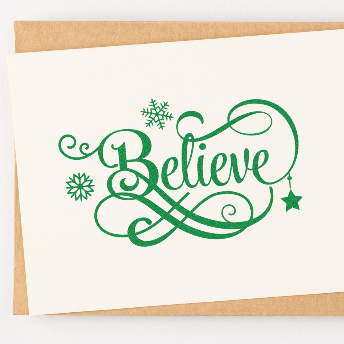 Green Believe rubber stamp design for holiday cards, with festive snowflakes, swirls, and a hanging star.