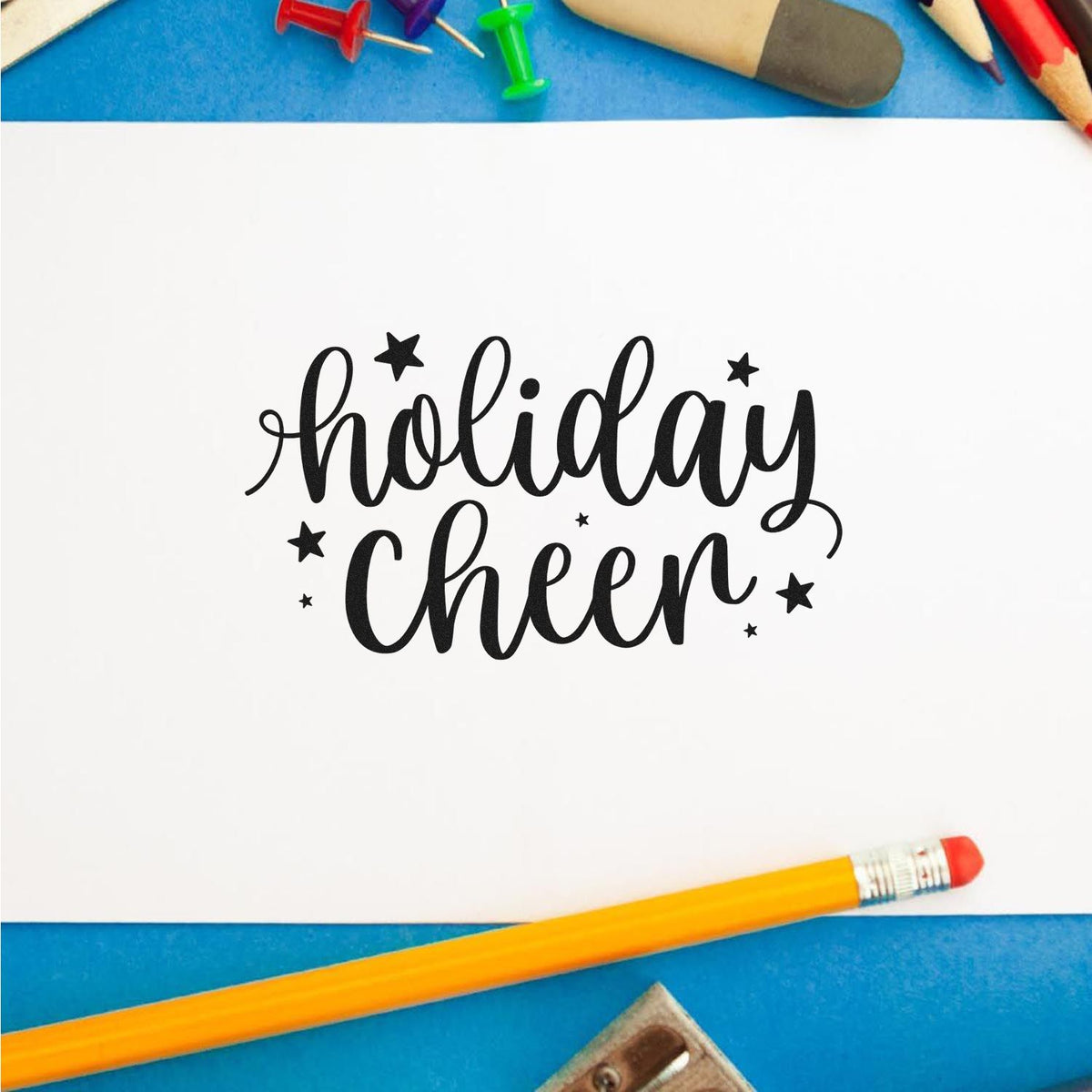 Holiday Cheer rubber stamp impression on paper, perfect for festive card making, scrapbooking, and holiday crafts.