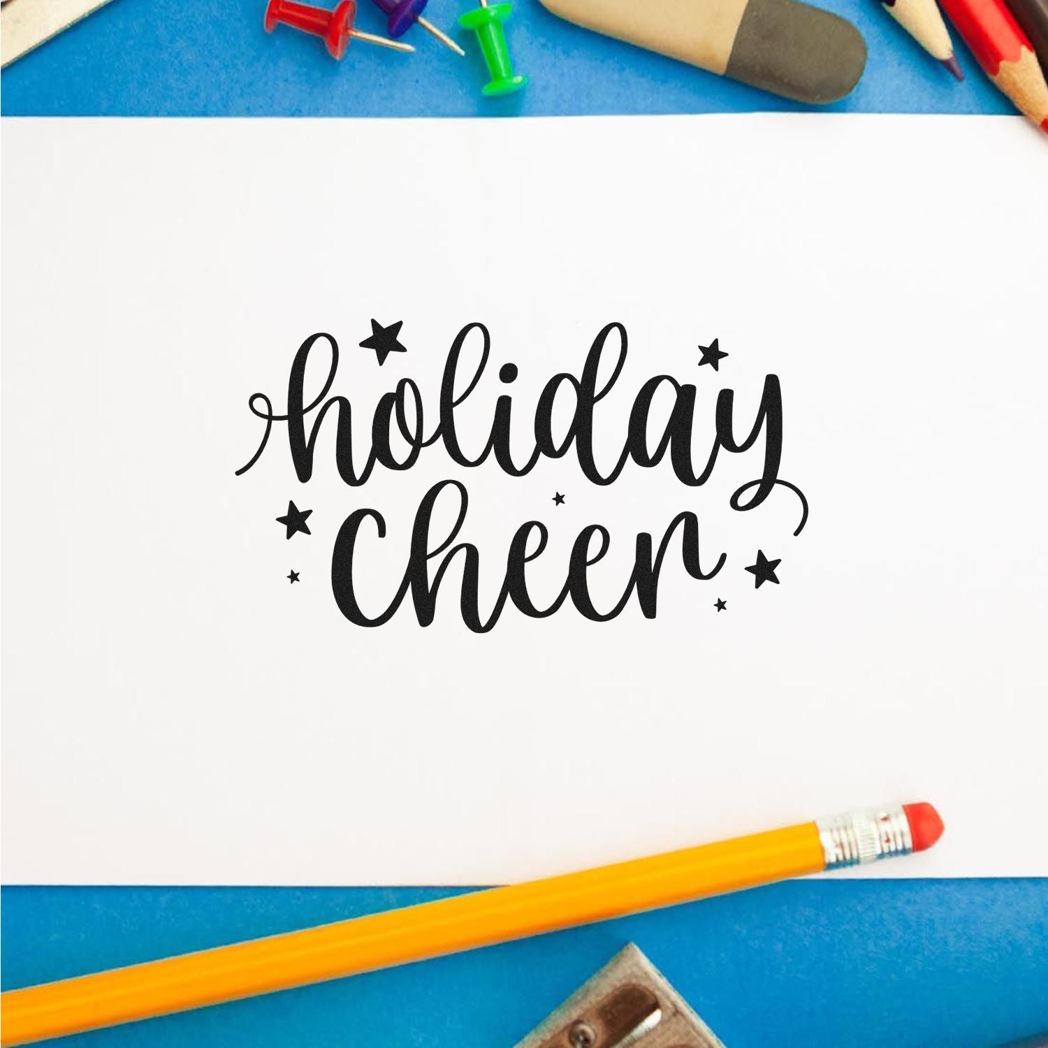 Holiday Cheer rubber stamp design on paper with star accents, ideal for festive card making, scrapbooking, and holiday crafts.