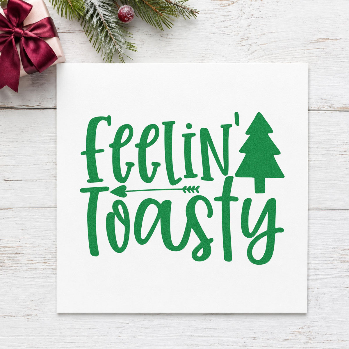 Feelin Toasty Christmas Tree craft stamp imprint in green ink on a handmade project, one idea being slipper gift tags.
