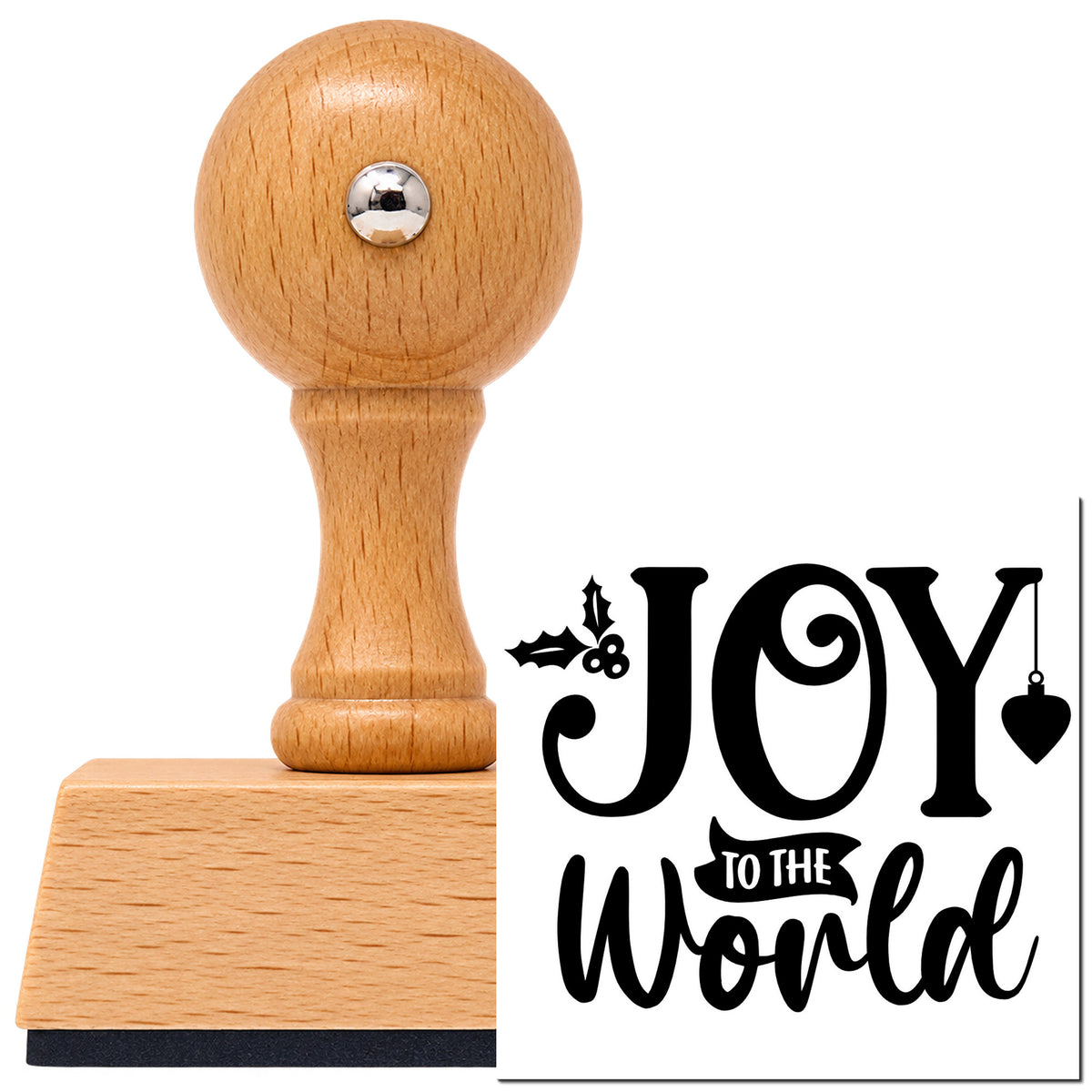 Joy To The World Holly Vintage Pro rubber stamp in European beech wood with a round knob handle, shown beside its black imprint.