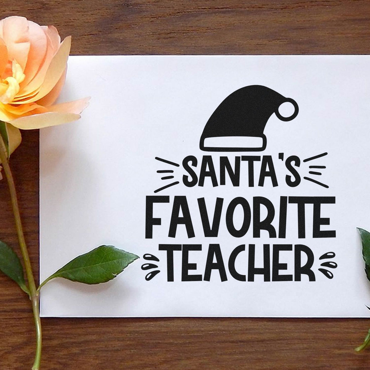 Santas Favorite Teacher rubber stamp design with Santa hat, perfect for holiday gifts, classroom crafts, and teacher appreciation.