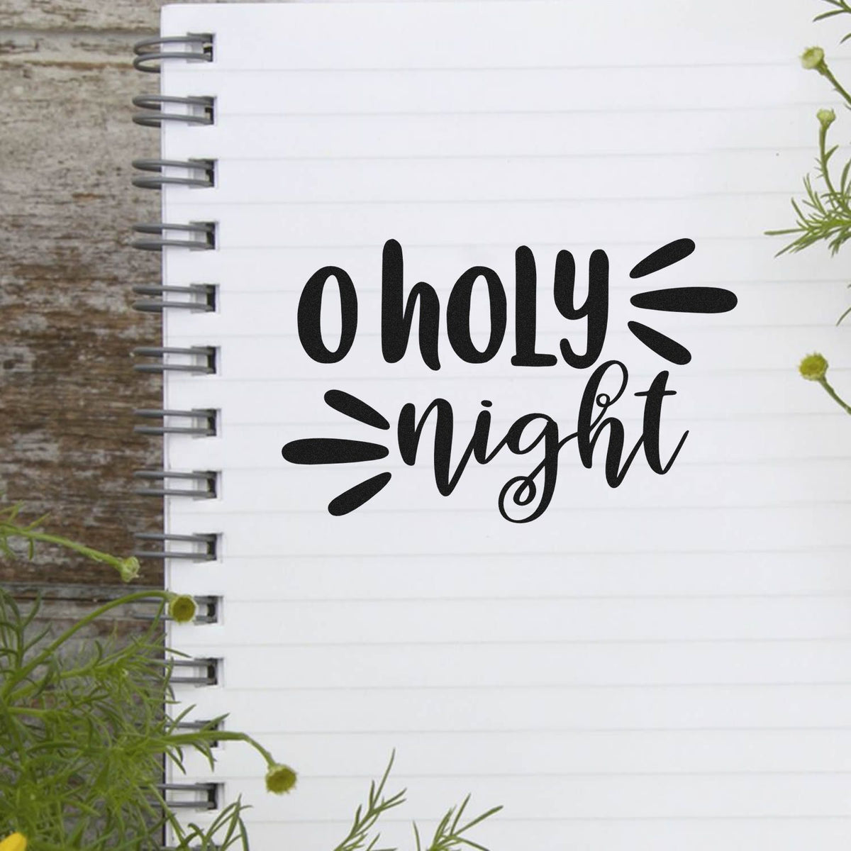 O Holy Night Christmas rubber stamp design mockup with hand-lettered script on a lined notebook page