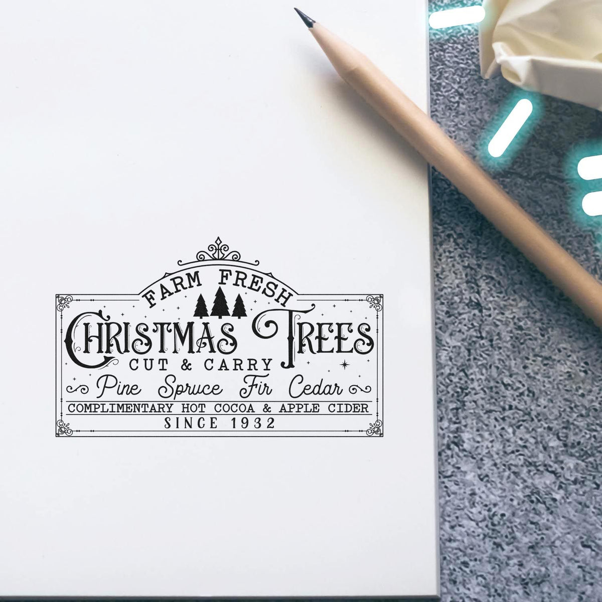 Christmas Trees rubber stamp impression on paper, featuring Farm Fresh holiday tree shop logo in vintage black ink.