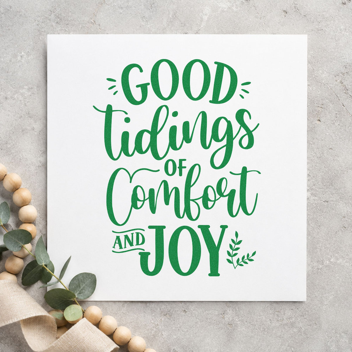 Good Tidings Comfort And Joy craft stamp imprint in green ink on a handmade project, one idea being meal train tags.