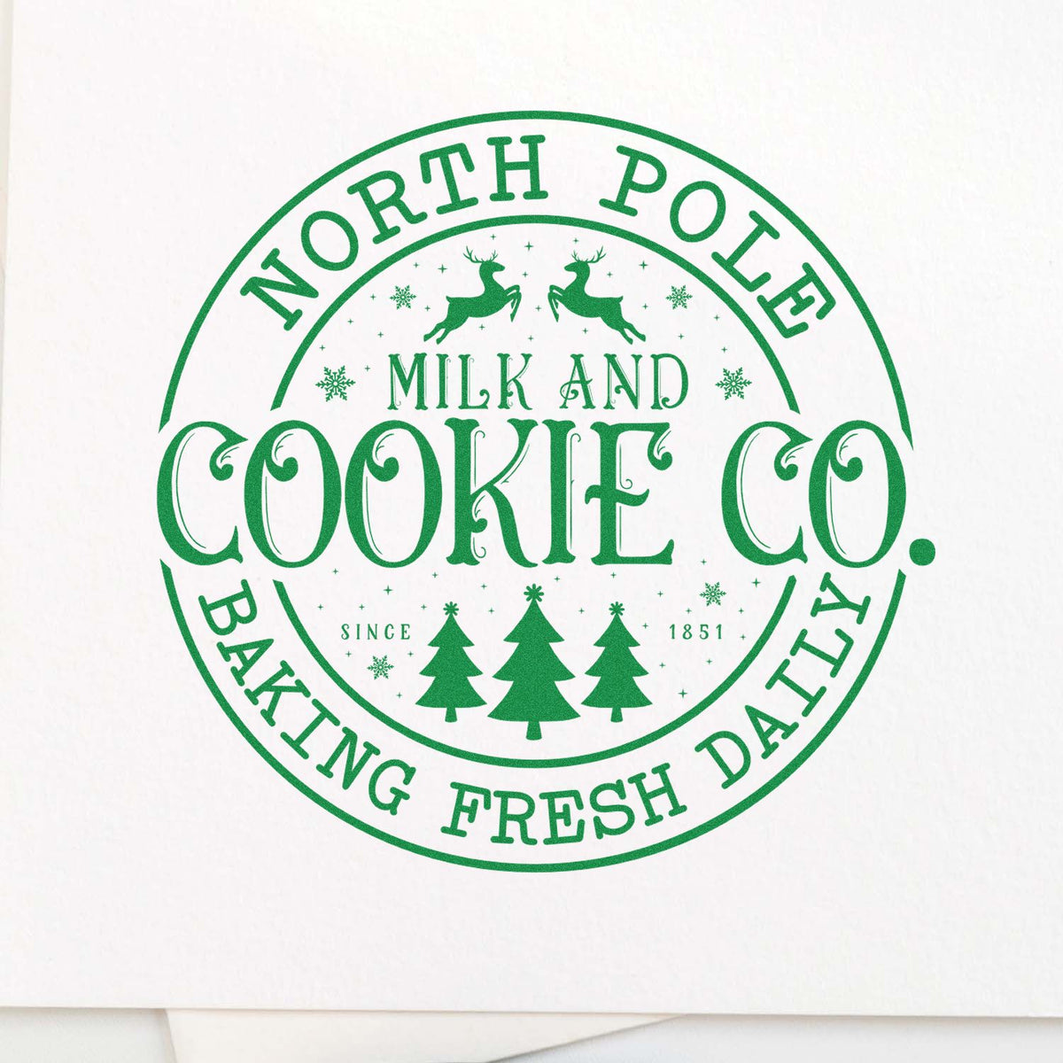 North Pole Milk and Cookie Co. baking fresh daily holiday rubber stamp design with deer, trees, and festive circle logo.
