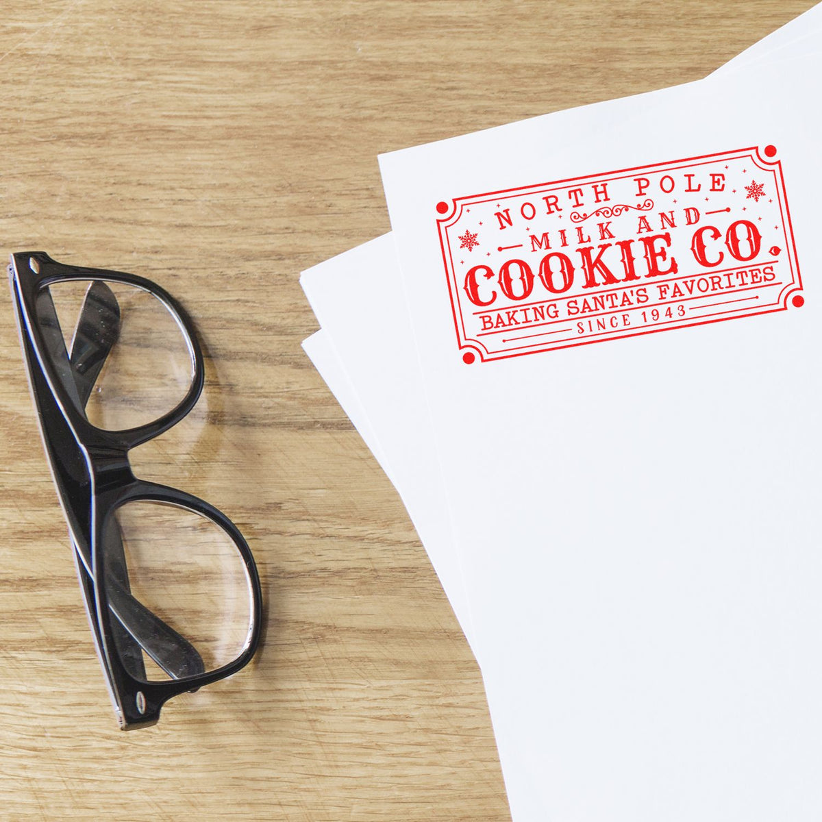 Custom rubber stamp imprint for North Pole Milk and Cookie Co on paper, perfect for holiday bakery packaging and gifts.