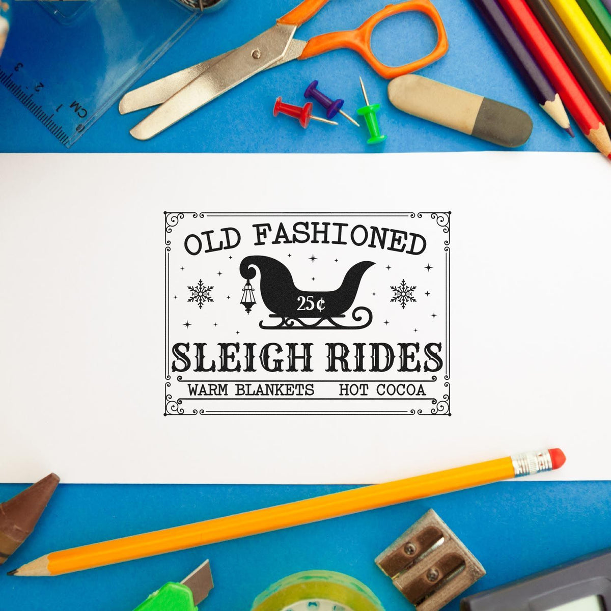 Old Fashioned Sleigh Rides rubber stamp design with warm blankets and hot cocoa on white paper, surrounded by school supplies.